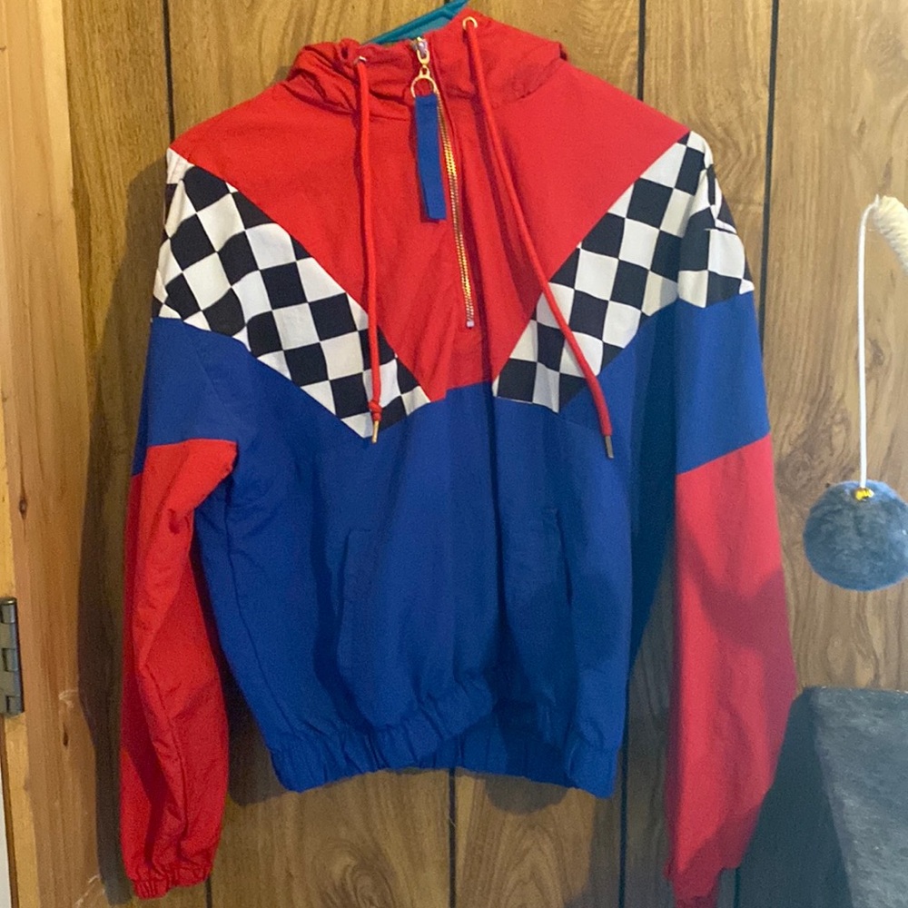 It’s a red and blue pull over jacket with a black and white checkered print.